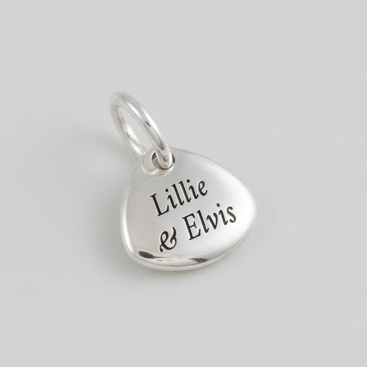 Silver paw print charm with personalized engraving, part of the Scarlett Jewellery charm collection.