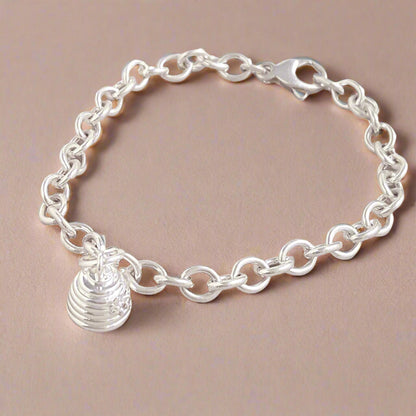 Silver beehive charm with detailed texture, hanging from a chain, by Scarlett Jewellery.