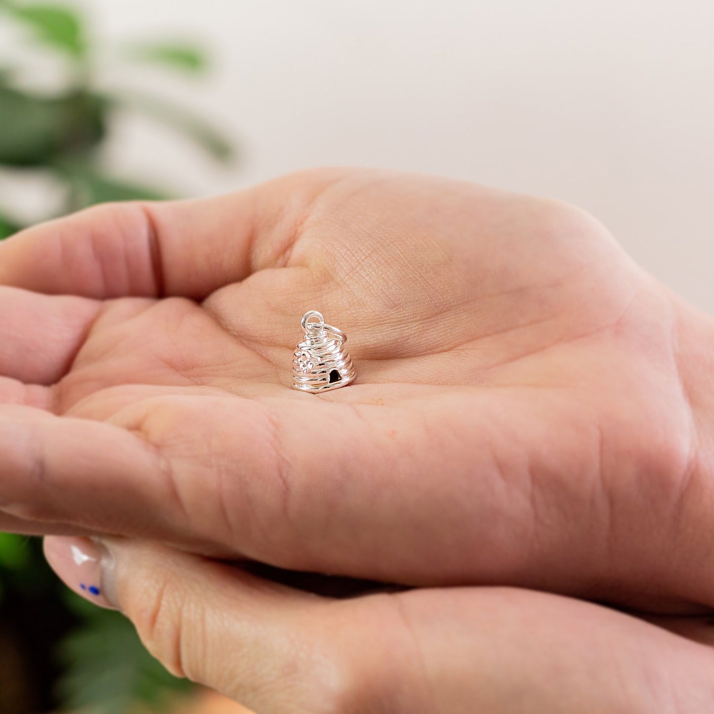 Silver beehive charm with detailed texture, displayed on a soft white background by Scarlett Jewellery.