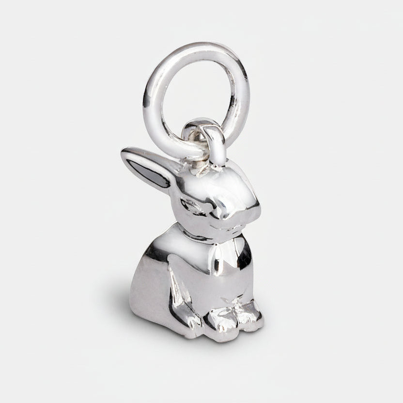 A silver bunny rabbit charm with detailed texture, shown against a soft background, by Scarlett Jewellery.