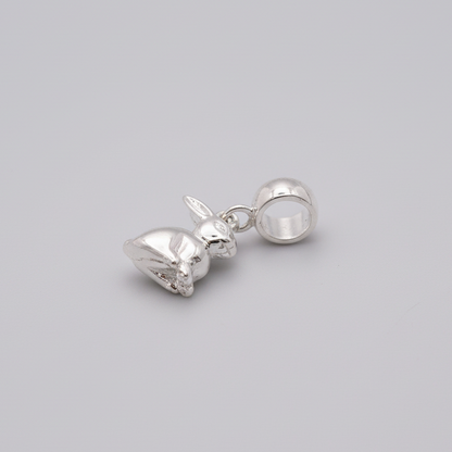 A silver bunny rabbit charm with detailed texture, displayed on a soft white background by Scarlett Jewellery.