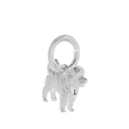 A silver cavapoo dog charm shaped like a small dog, detailed with a smooth finish and delicate features, by Scarlett Jeweller