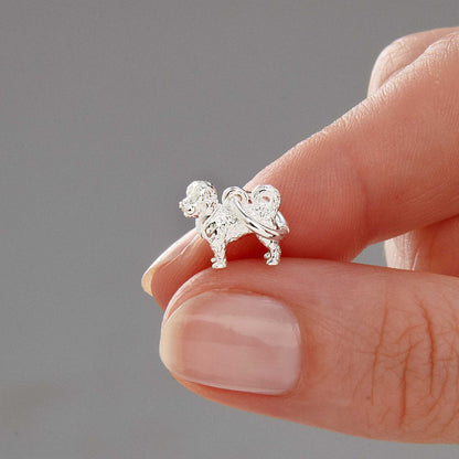 Silver dog-shaped charm with intricate detailing, styled on a leather cord, by Scarlett Jewellery.