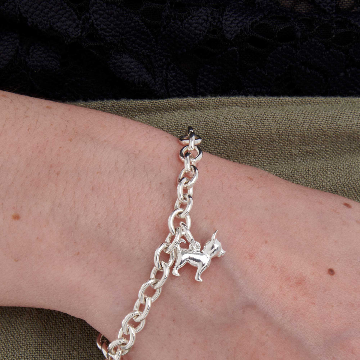 A silver chihuahua dog charm with detailed features, displayed on a white background by Scarlett Jewellery.