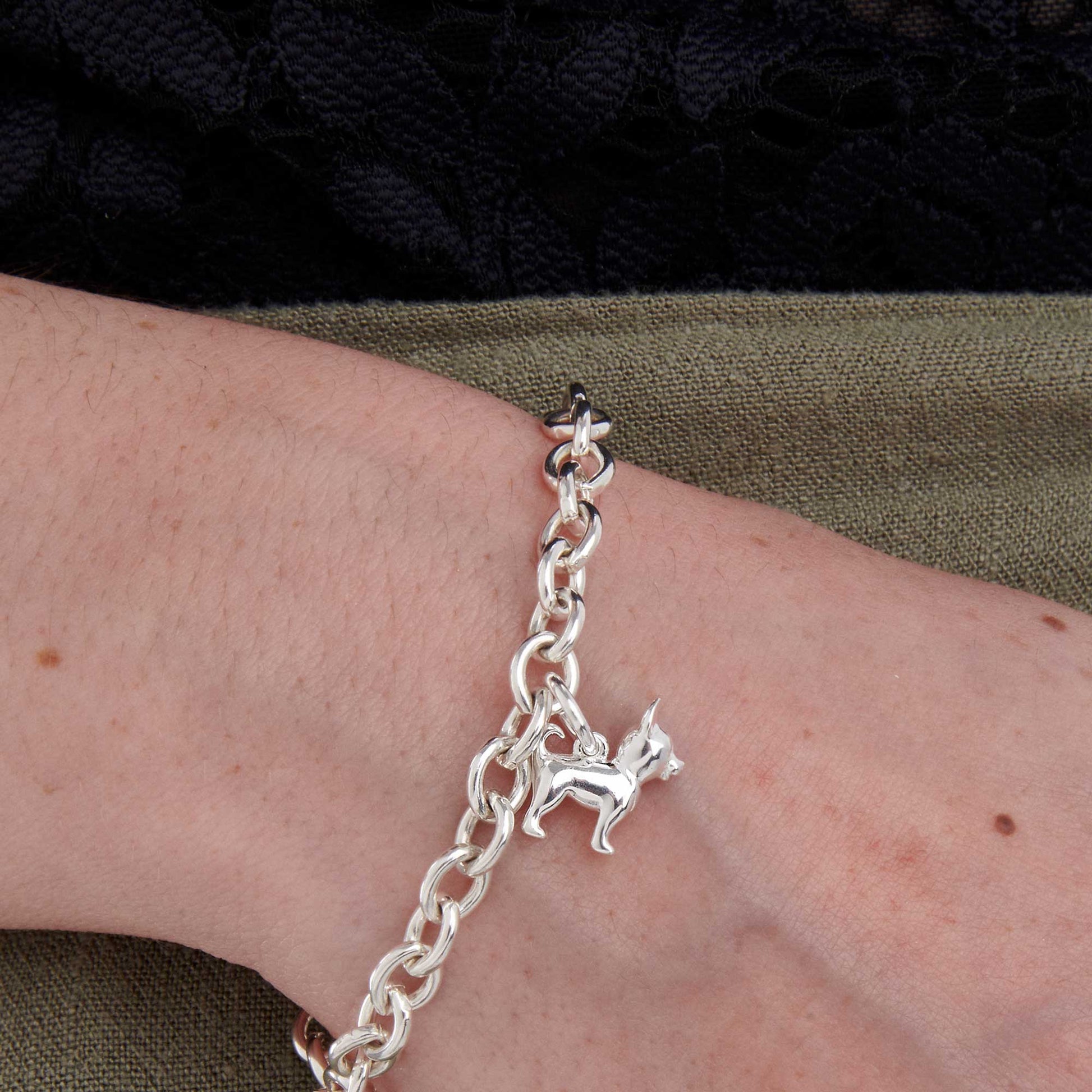 A silver chihuahua dog charm with detailed features, displayed on a white background by Scarlett Jewellery.
