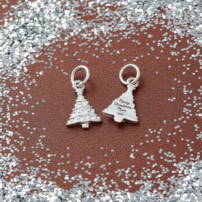 A silver Christmas tree charm with personalized engraving, displayed on a white background, by Scarlett Jewellery.