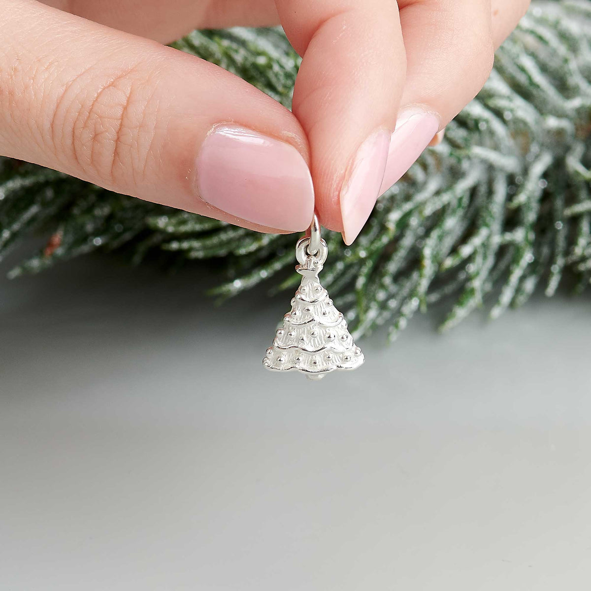 Silver personalised Christmas tree charm with engraved name and date by Scarlett Jewellery.