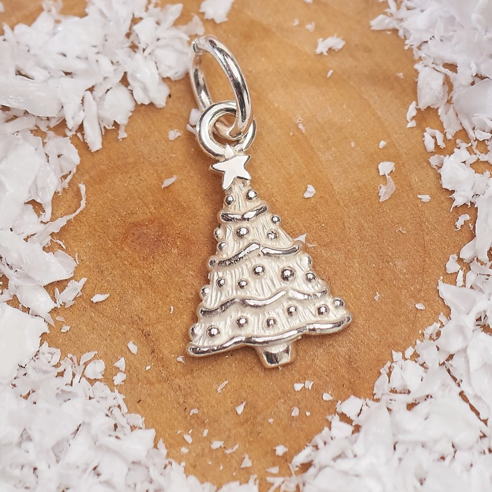 Silver personalised Christmas tree charm with engraved name details by Scarlett Jewellery.