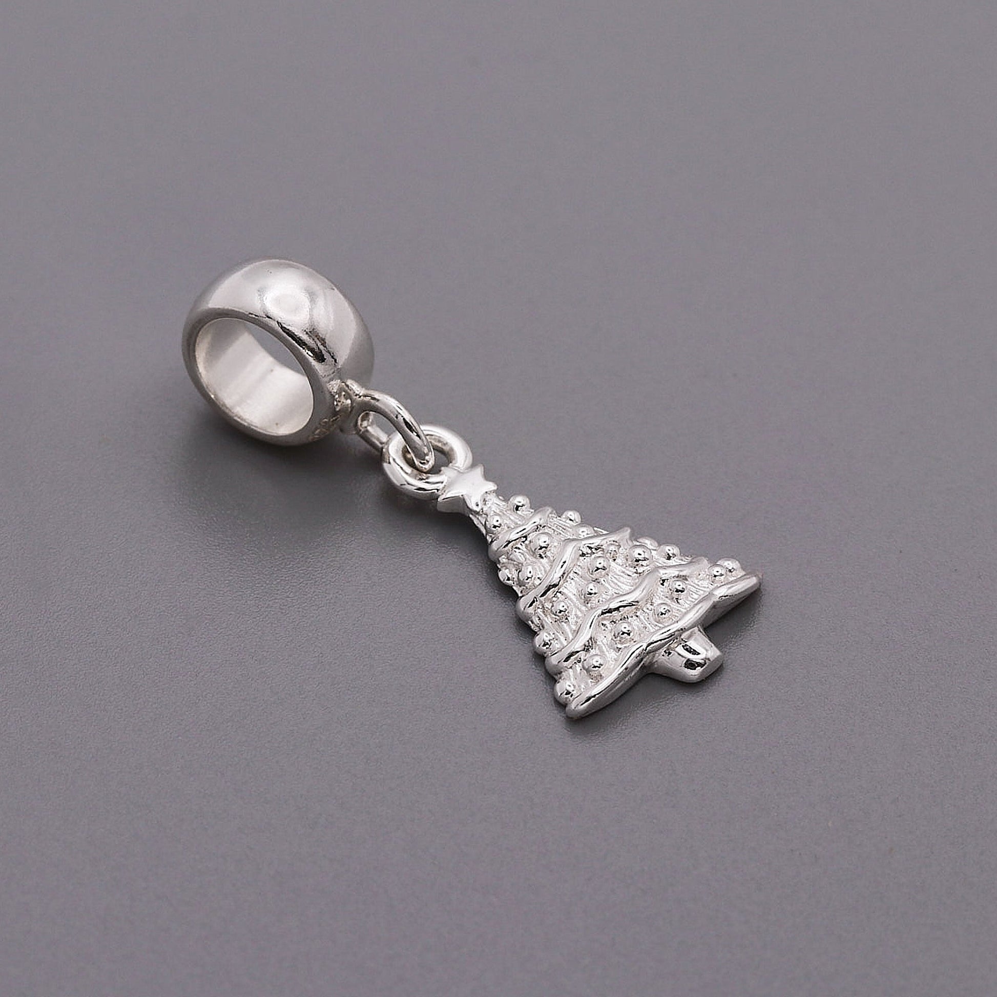 Silver personalised Christmas tree charm with engraved name and date by Scarlett Jewellery.