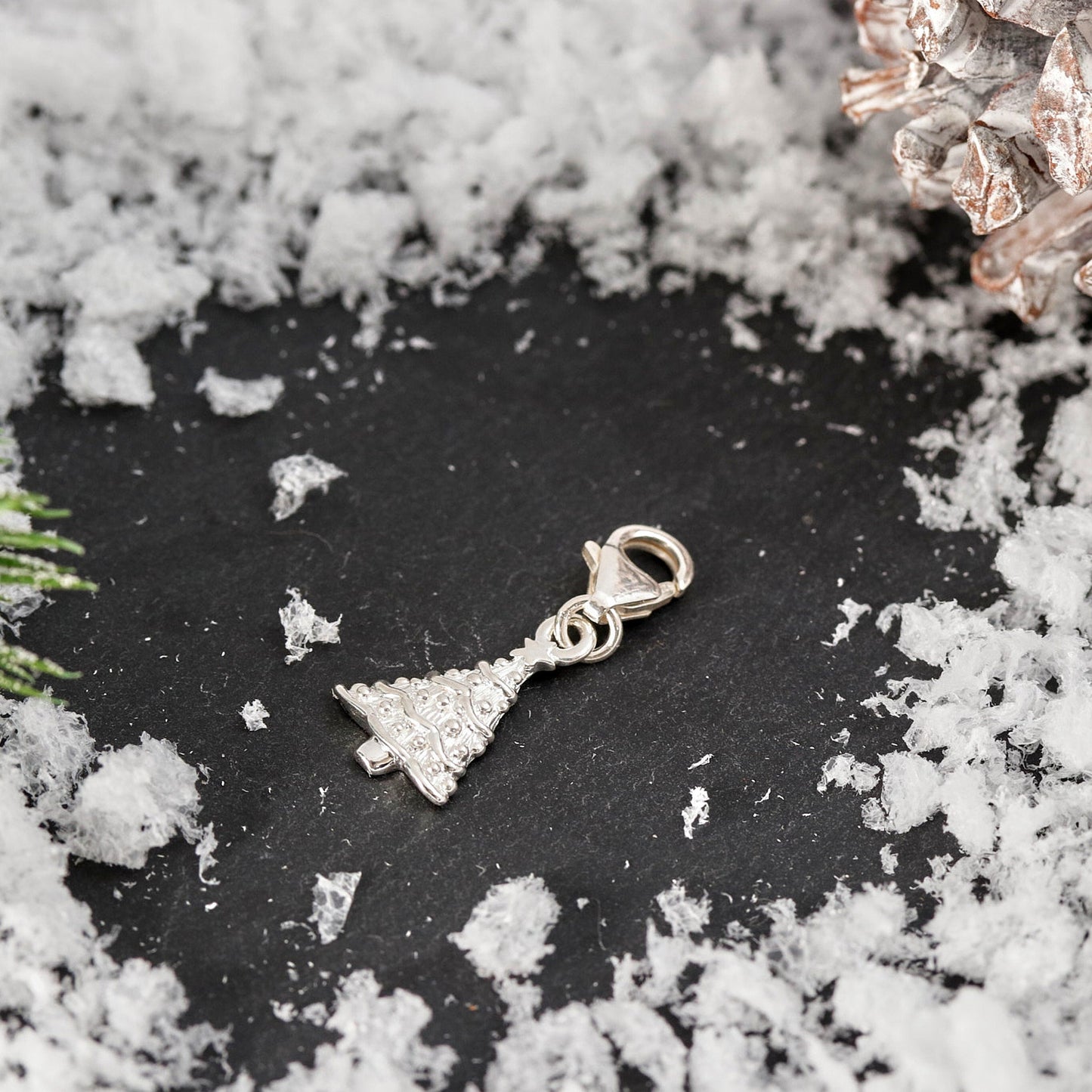 Silver personalised Christmas tree charm with engraved name and date by Scarlett Jewellery.