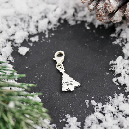 A silver Christmas tree charm with personalized engraving, displayed on a white background, by Scarlett Jewellery.