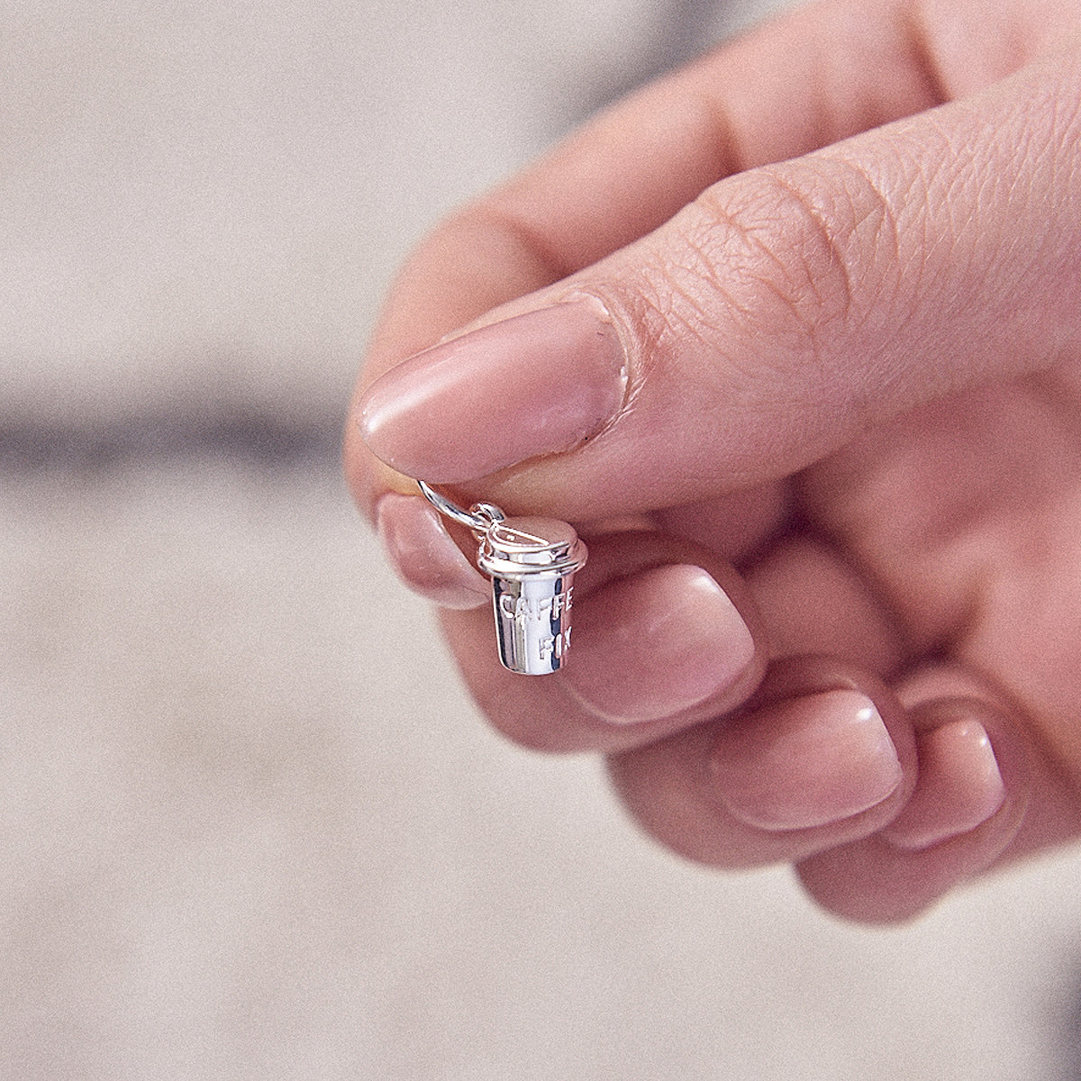 Silver coffee cup charm with delicate detailing, part of the Scarlett Jewellery collection.