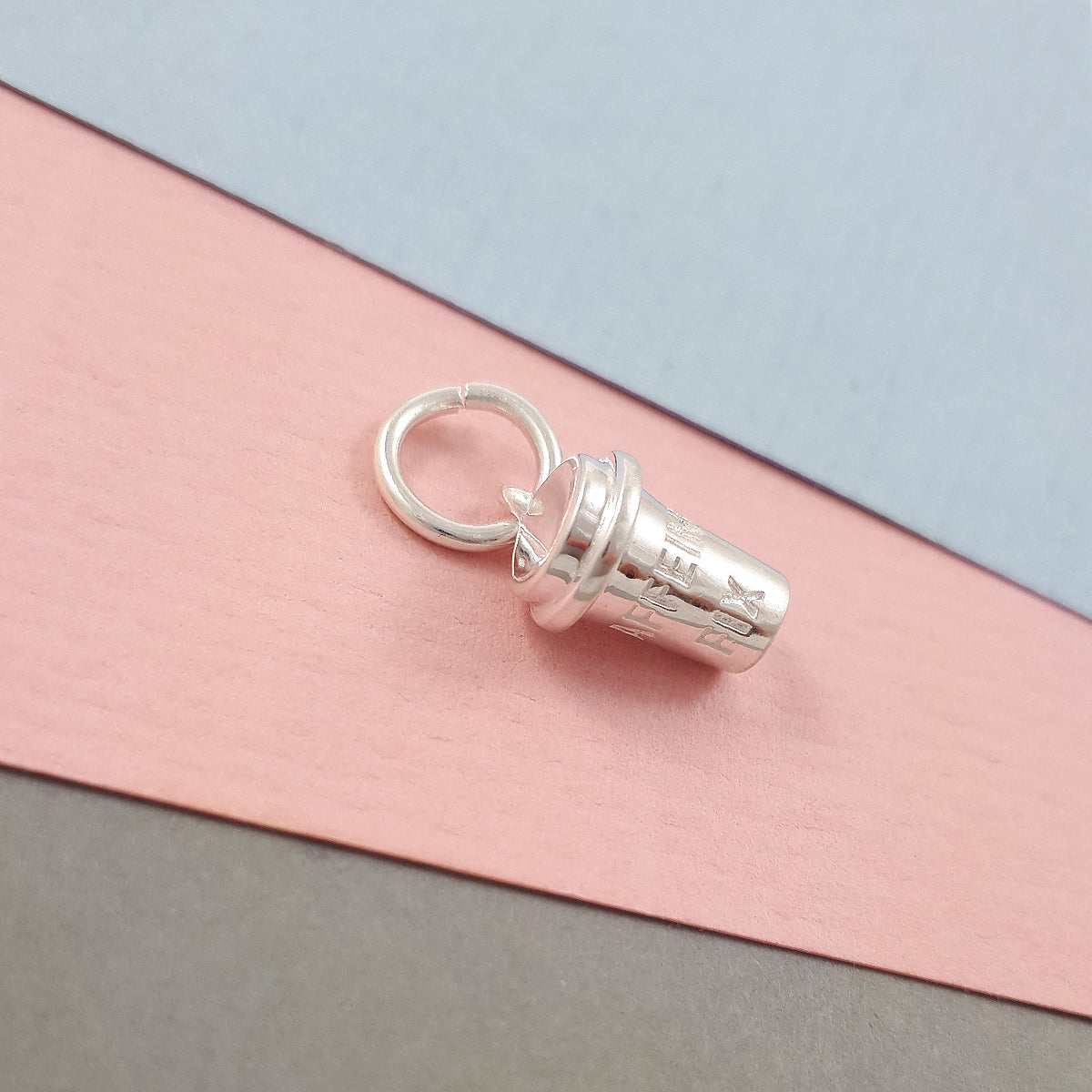 Silver coffee cup charm with intricate detailing, part of the Scarlett Jewellery collection.