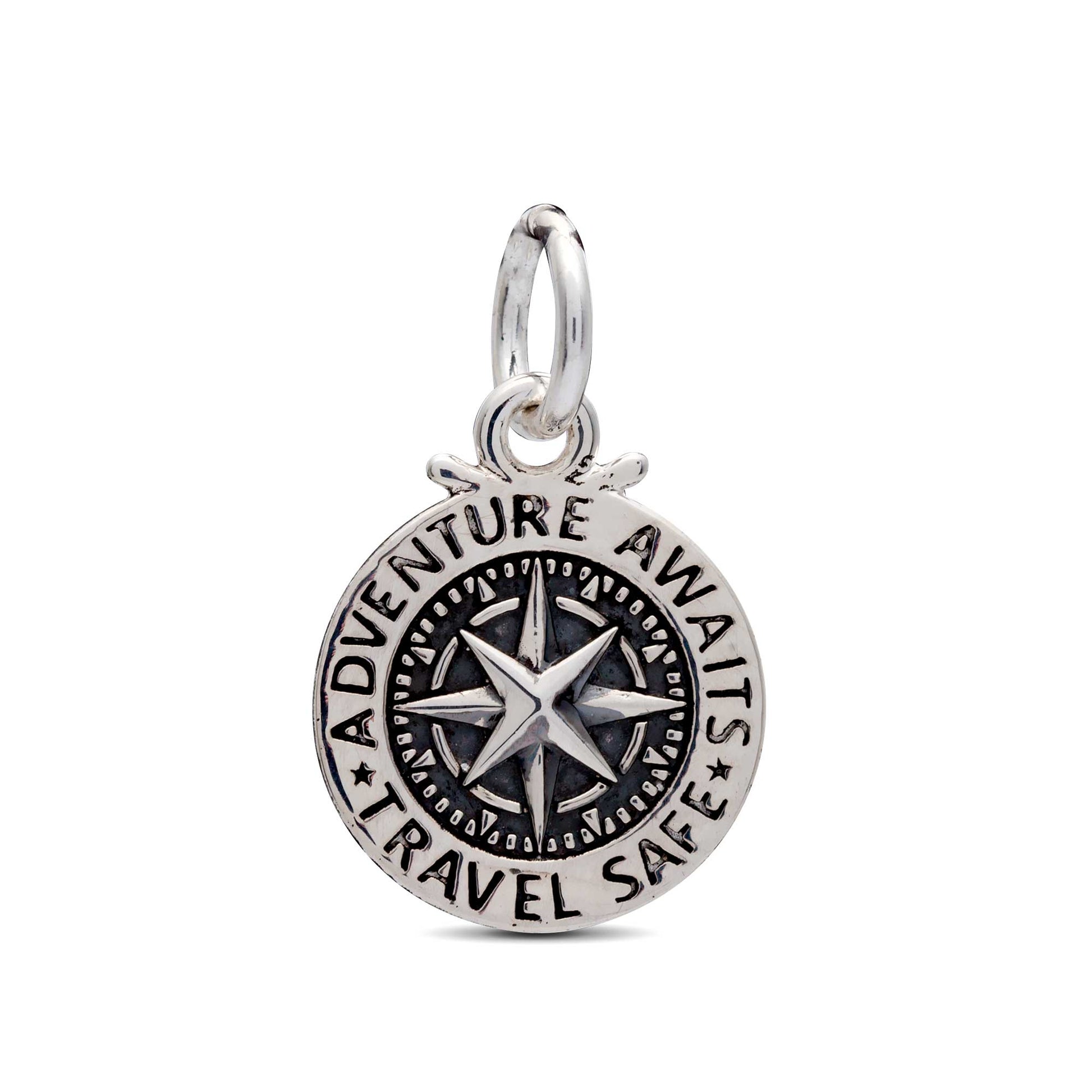 A silver travel safe compass charm with personalized engraving, displayed on a soft background by Scarlett Jewellery.