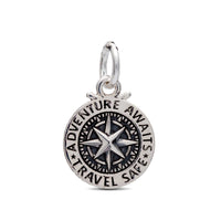 A silver travel safe compass charm with personalized engraving, displayed on a soft background by Scarlett Jewellery.