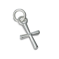 A silver cross charm with intricate detailing, displayed on a soft white background by Scarlett Jewellery.