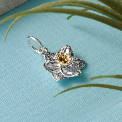 A daffodil flower silver and solid gold charm with detailed petal texture by Scarlett Jewellery.