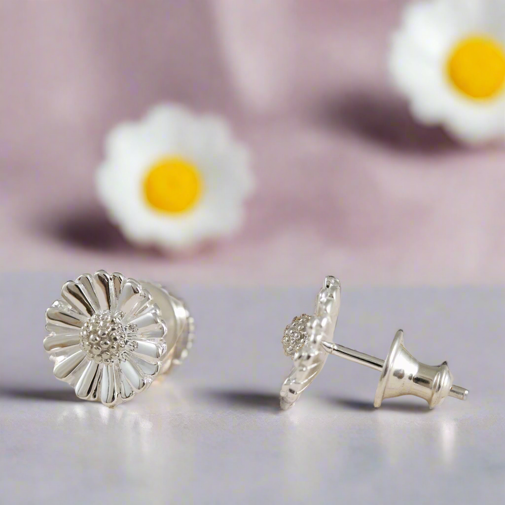 Daisy silver stud earrings with floral details, close-up shot, by Scarlett Jewellery.