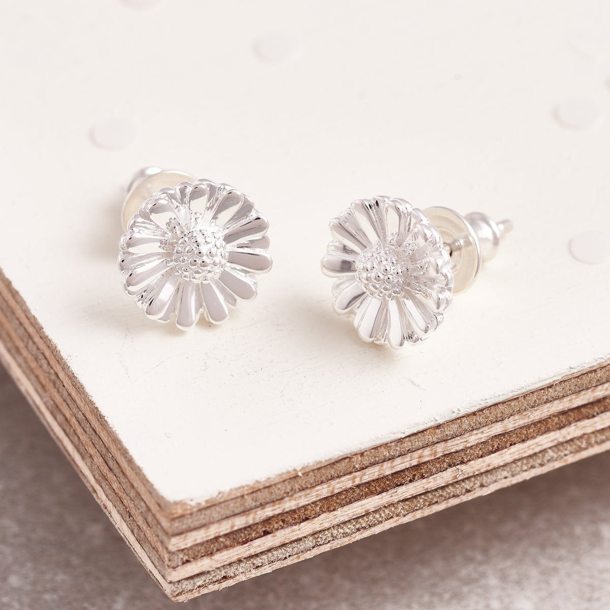 Daisy silver stud earrings with delicate floral design by Scarlett Jewellery.