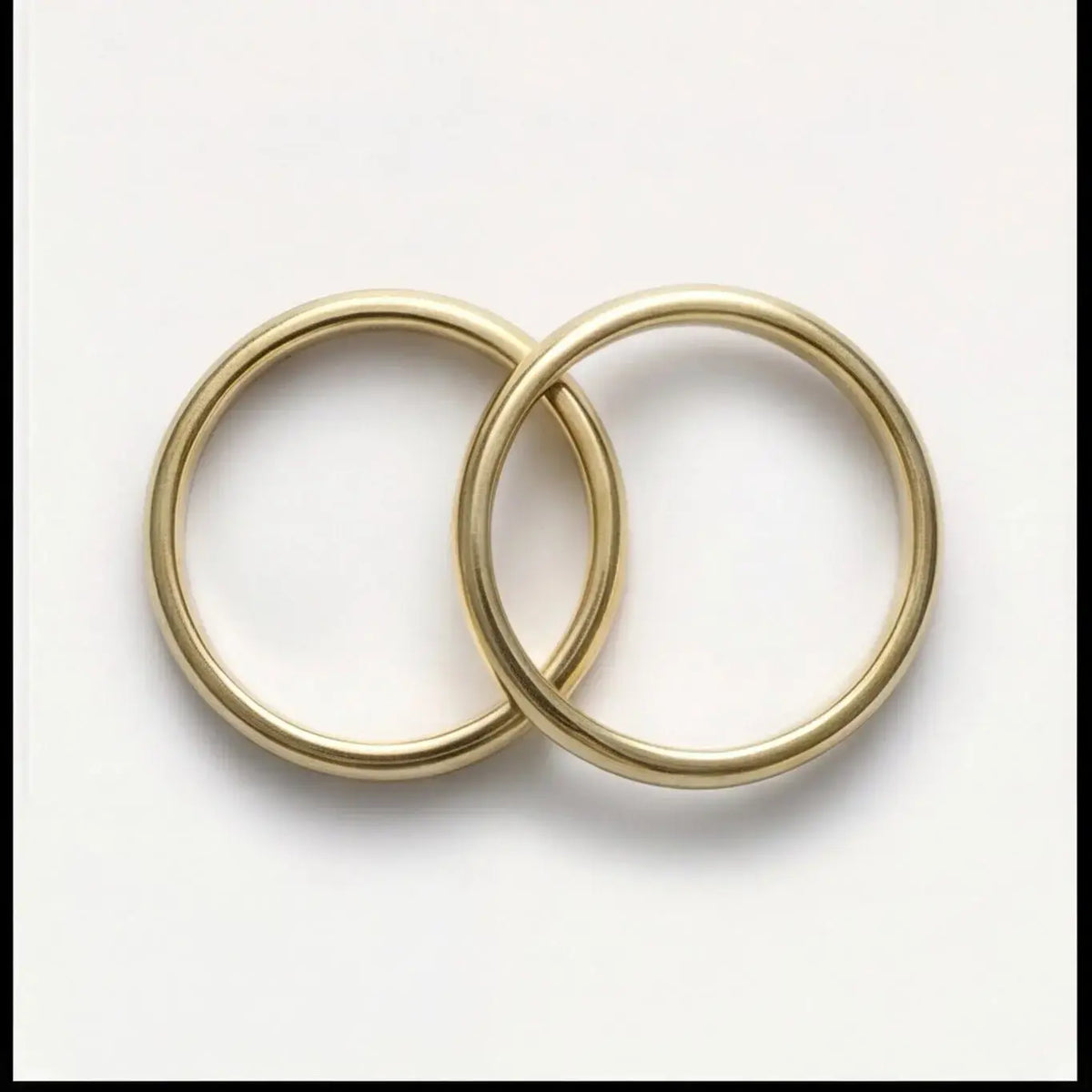 A 3mm gold wedding band featuring a classic lyra design in 9ct gold, displayed horizontally with a subtle shine by Majestic J