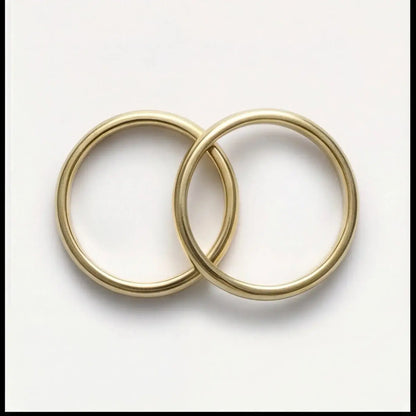 A 3mm gold wedding band featuring a classic lyra design in 9ct gold, displayed horizontally with a subtle shine by Majestic J