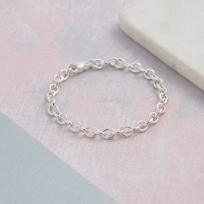 A silver mini lifetime charm bracelet with a delicate chain and personalized charms by Scarlett Jewellery.