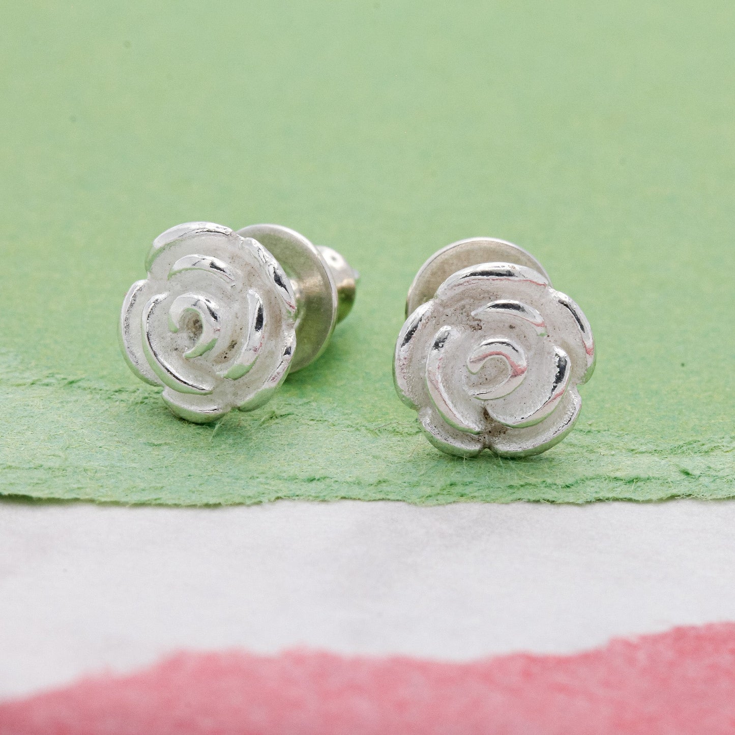 Silver rose flower stud earrings with detailed petal texture by Scarlett Jewellery.
