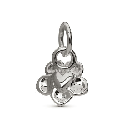 Silver forget-me-not flower charm with personalized engraving, displayed on a velvet background by Scarlett Jewellery.