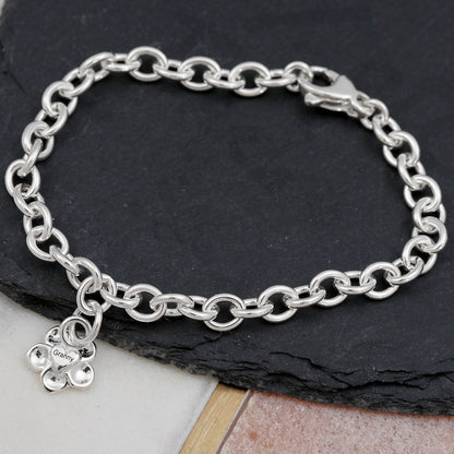 A silver personalised charm bracelet with a forget-me-not design by Scarlett Jewellery