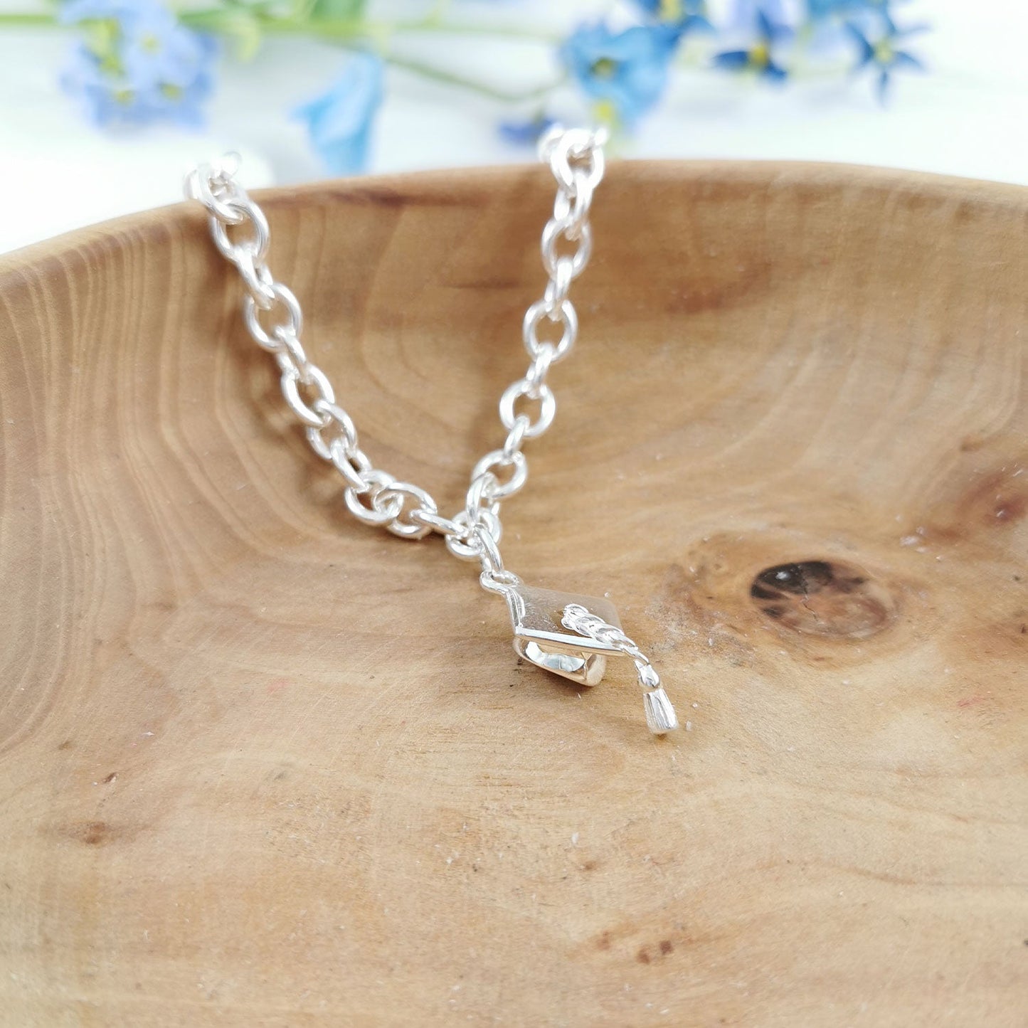 Silver charm bracelet with personalized mortar board charm by Scarlett Jewellery.