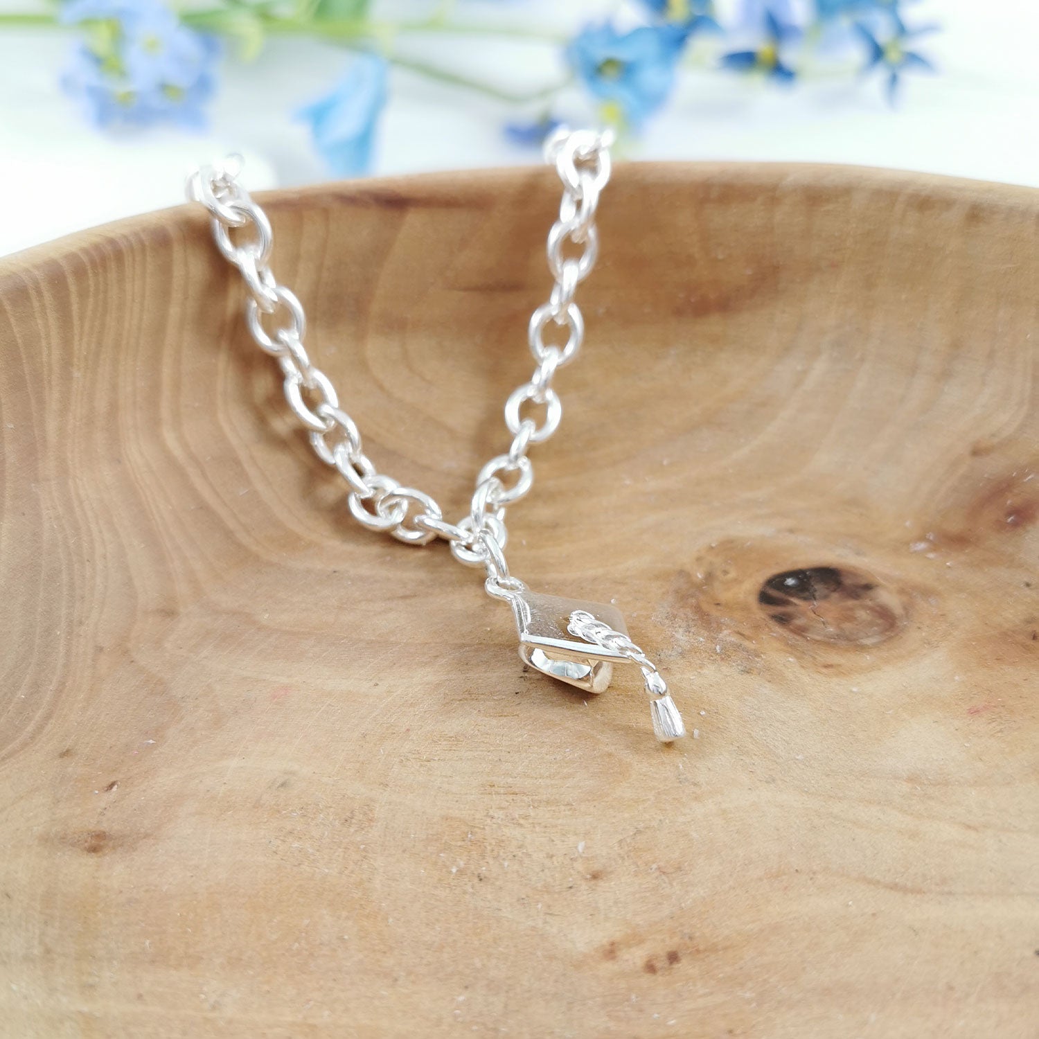 Silver charm bracelet with personalized mortar board charm by Scarlett Jewellery.