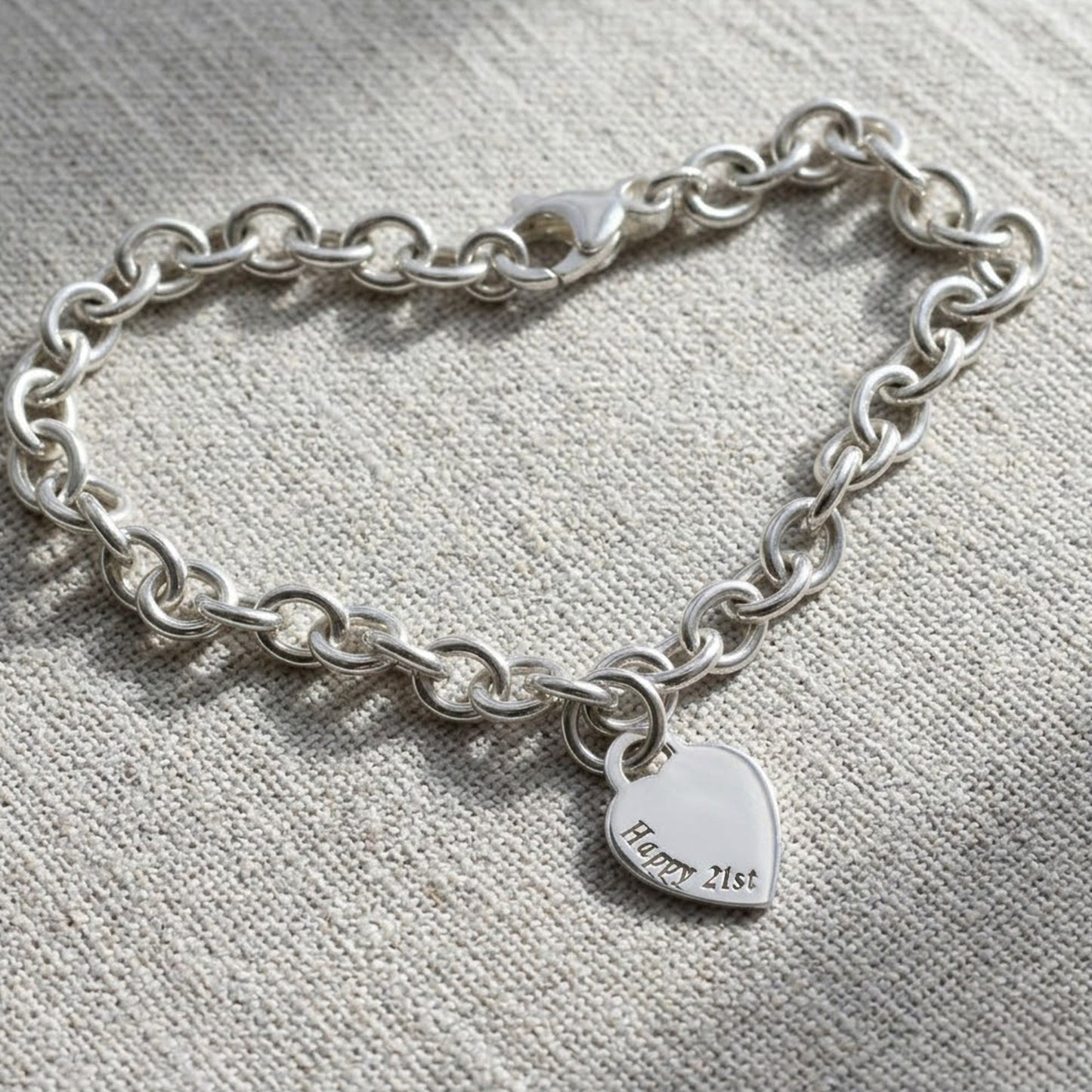 A silver heart tag charm bracelet with personalized engraving by Scarlett Jewellery