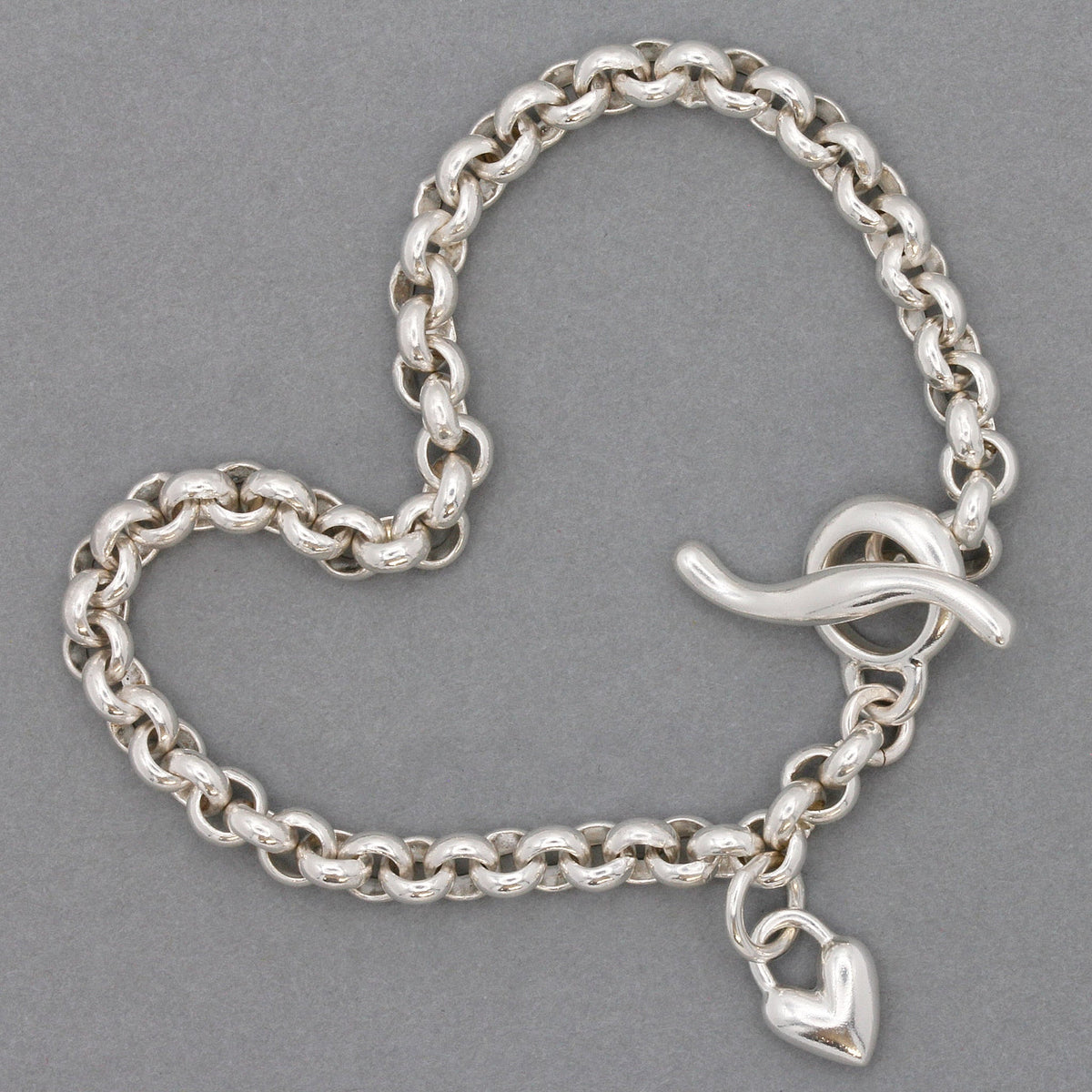 A silver heart belcher chain charm bracelet with a detailed heart charm by Scarlett Jewellery.