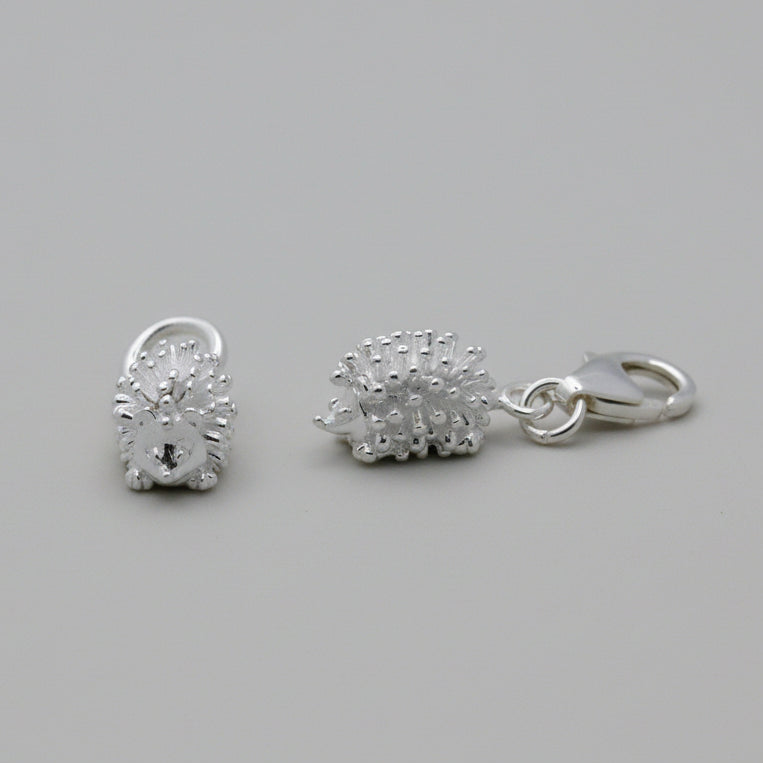 Silver hedgehog charm with intricate detailing, displayed on a soft velvet background, part of the Scarlett Jewellery collect