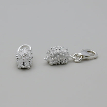 Silver hedgehog charm with intricate detailing, displayed on a soft velvet background, part of the Scarlett Jewellery collect