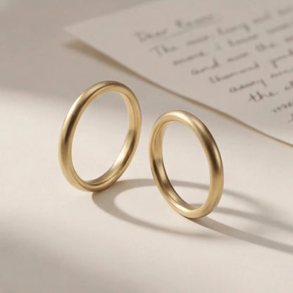A slim gold wedding band set featuring a 2mm width in 9ct, 14ct, and 18ct gold by Majestic Jewellery.