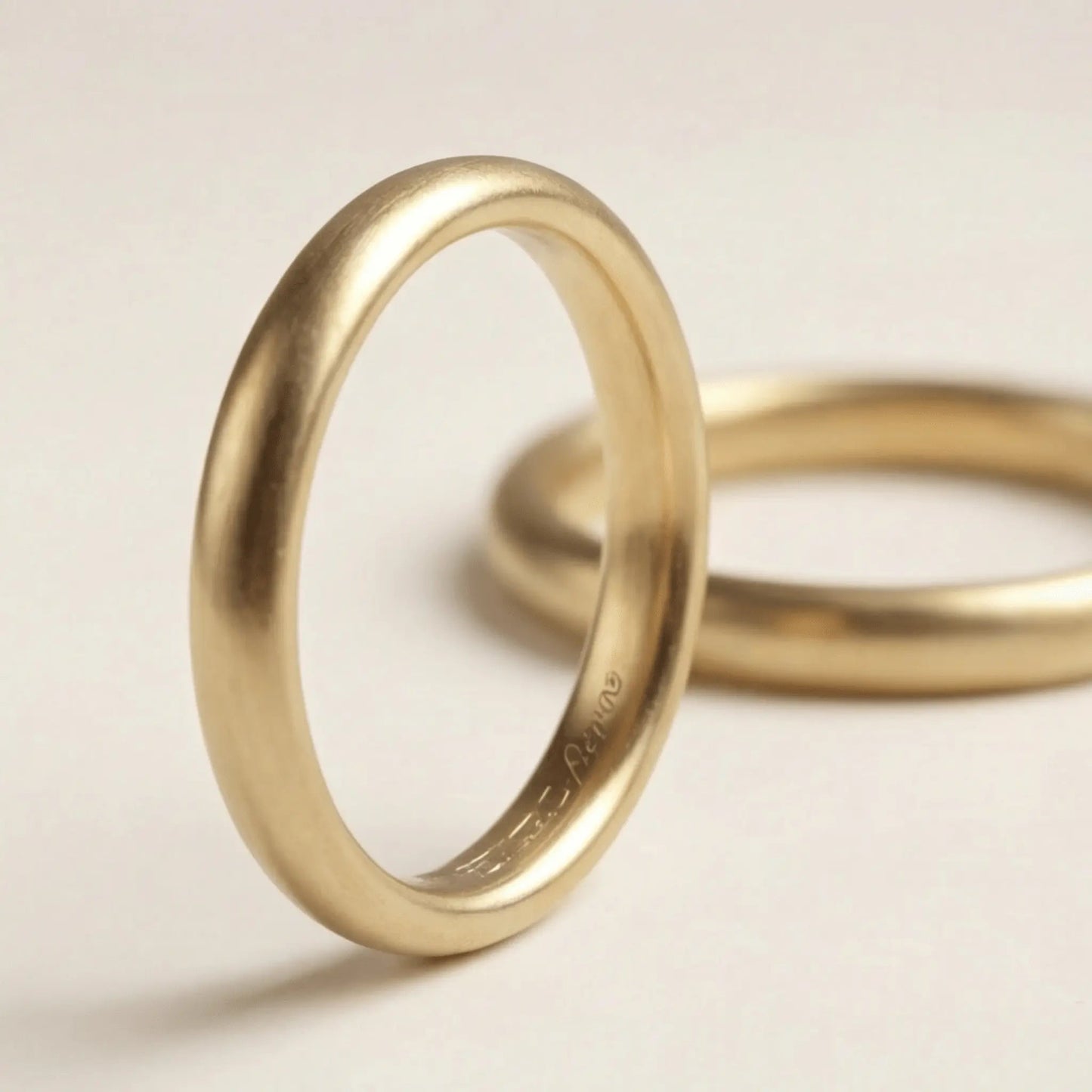 A slim gold wedding band set featuring a 2mm width in 9ct, 14ct, and 18ct gold by Majestic Jewellery.