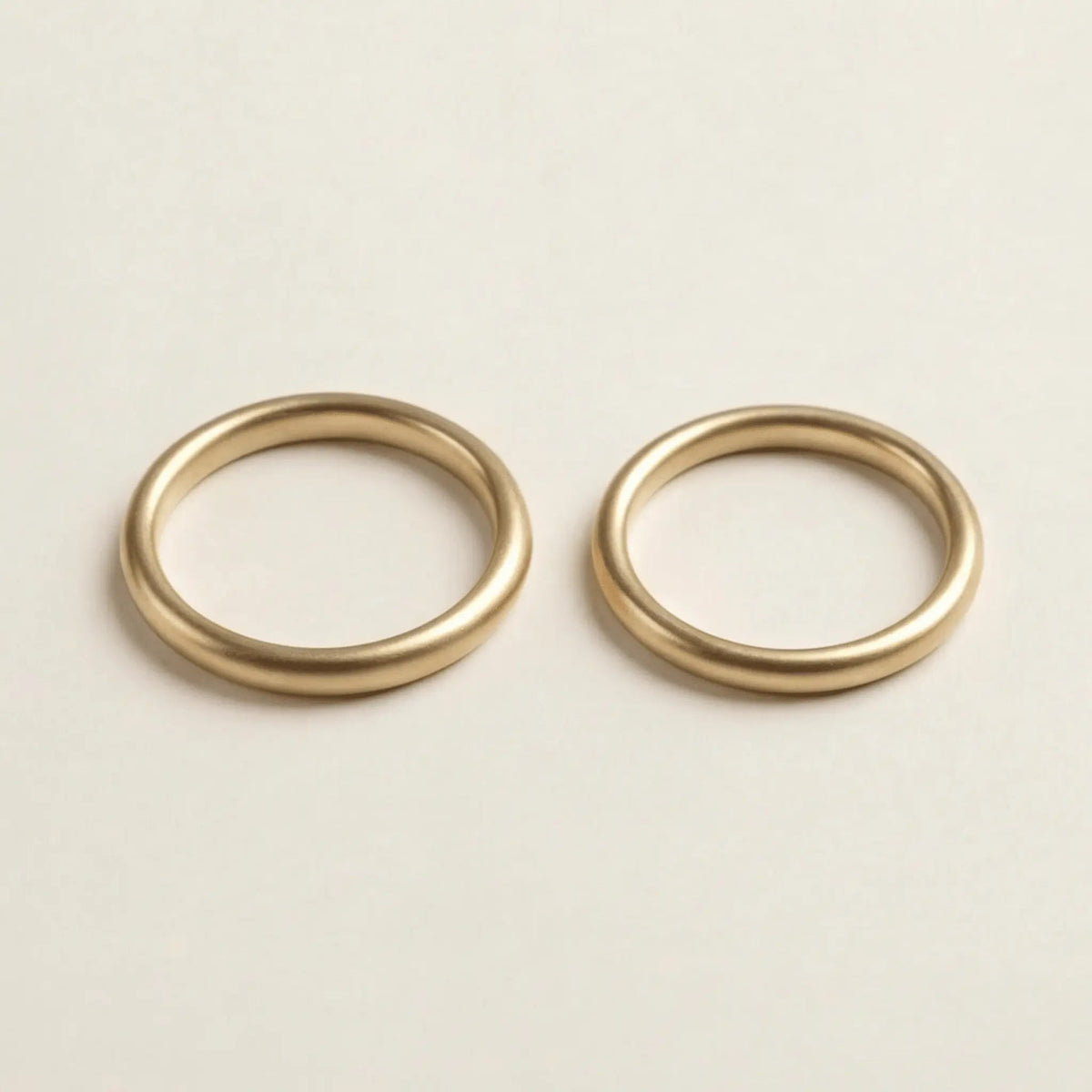 A slim gold wedding band set featuring a 2mm width in 9ct, 14ct, and 18ct gold by Majestic Jewellery.