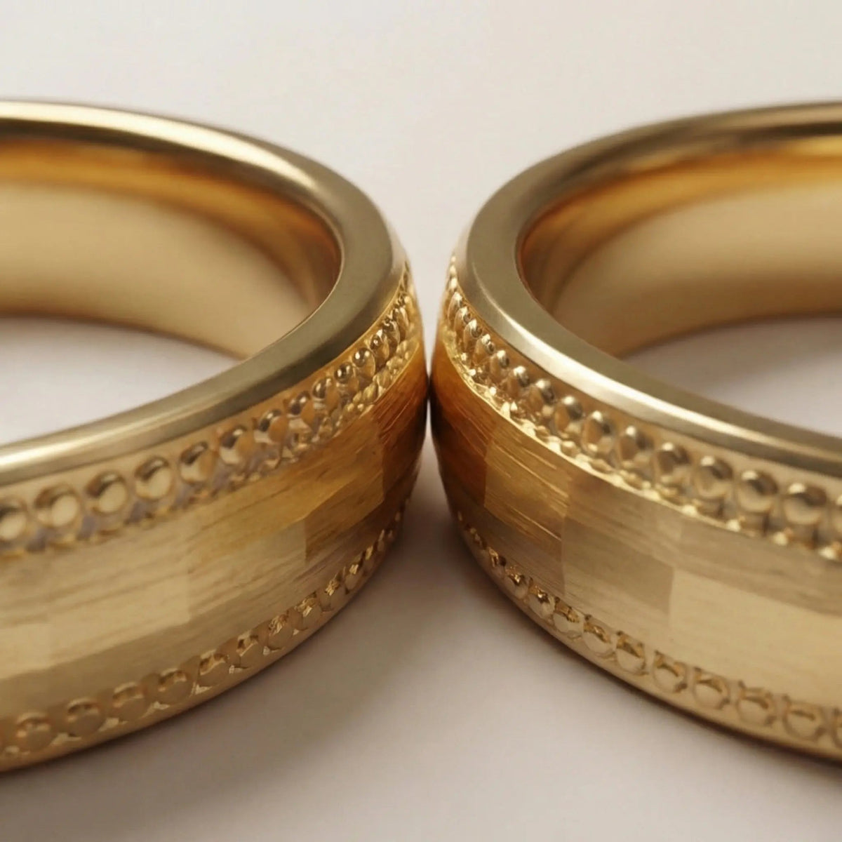 A 5mm gold wedding band with faceted milgrain detailing in 9ct gold, shown against a black background by Majestic Jewellery.