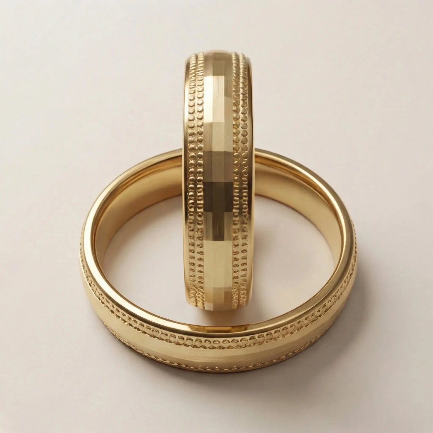 A 5mm gold wedding band with faceted milgrain detailing in 9ct gold, shown against a black background by Majestic Jewellery.
