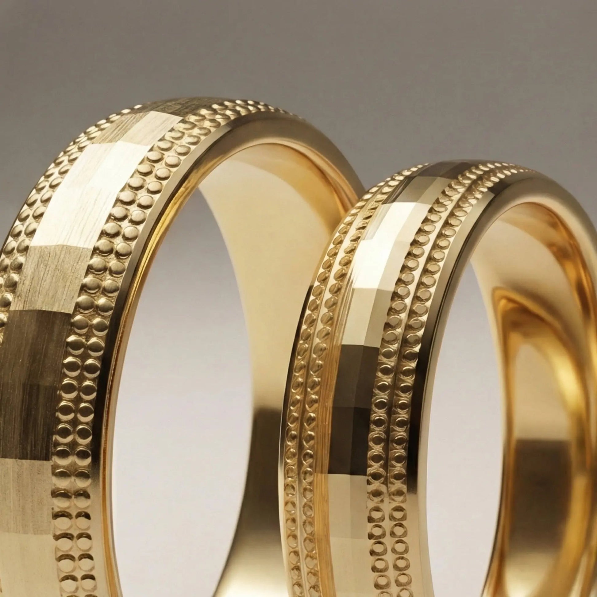 A 5mm gold wedding band with faceted milgrain detailing in 9ct gold, shown against a black background by Majestic Jewellery.
