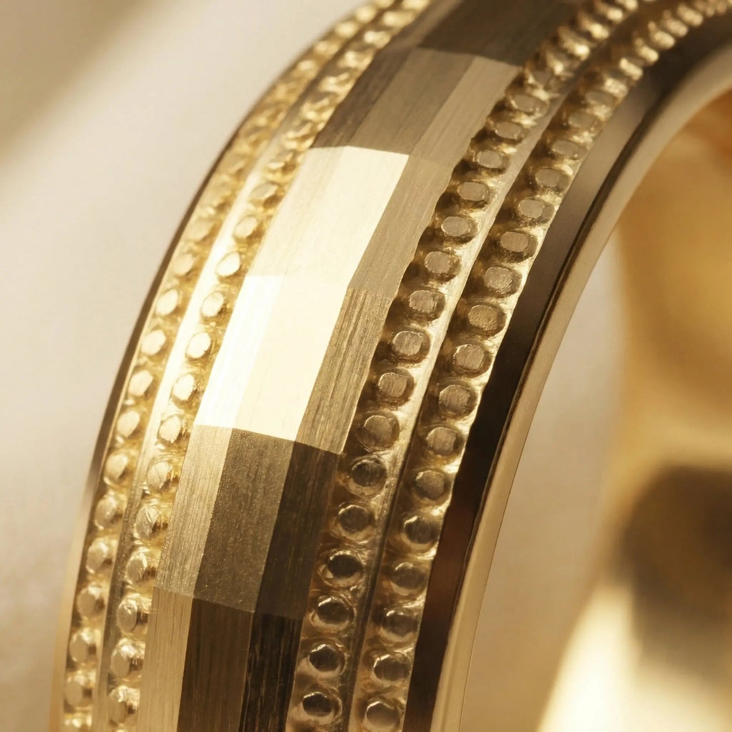 A 5mm gold wedding band with faceted milgrain detailing in 9ct gold, shown against a black background by Majestic Jewellery.