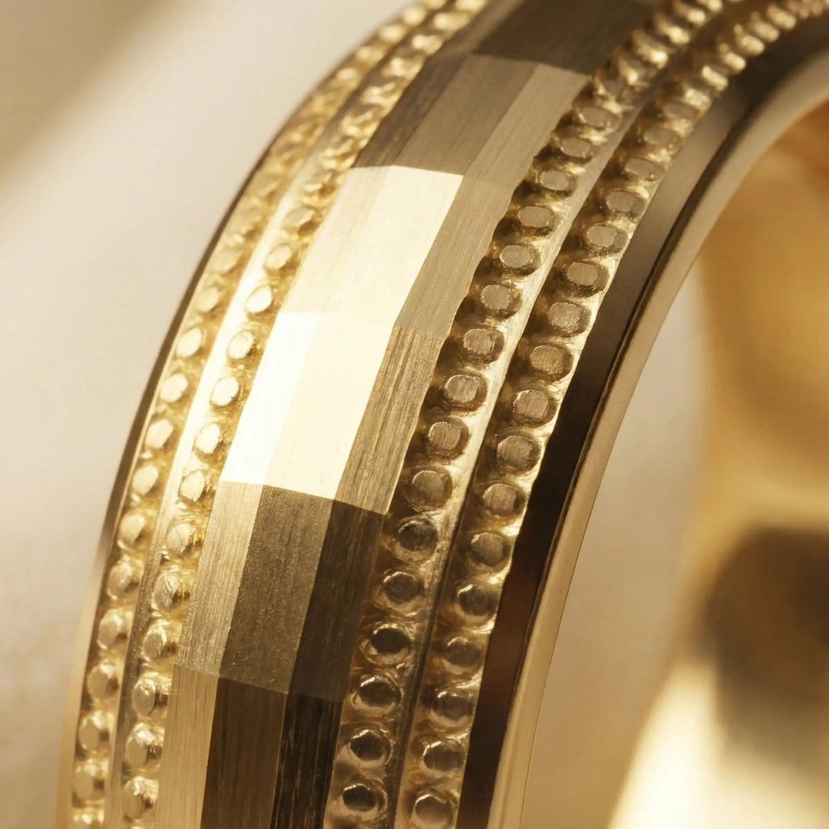 A 5mm gold wedding band with faceted milgrain detailing in 9ct gold, shown against a black background by Majestic Jewellery.