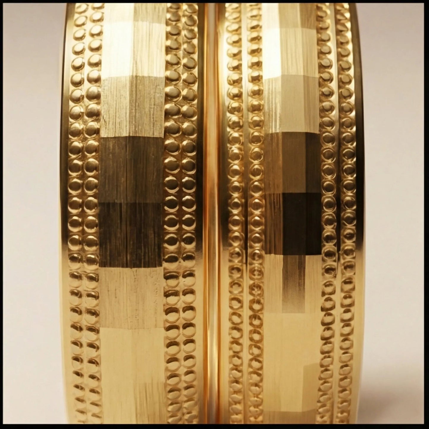 A 5mm gold wedding band with faceted milgrain detailing in 9ct gold, shown against a black background by Majestic Jewellery.