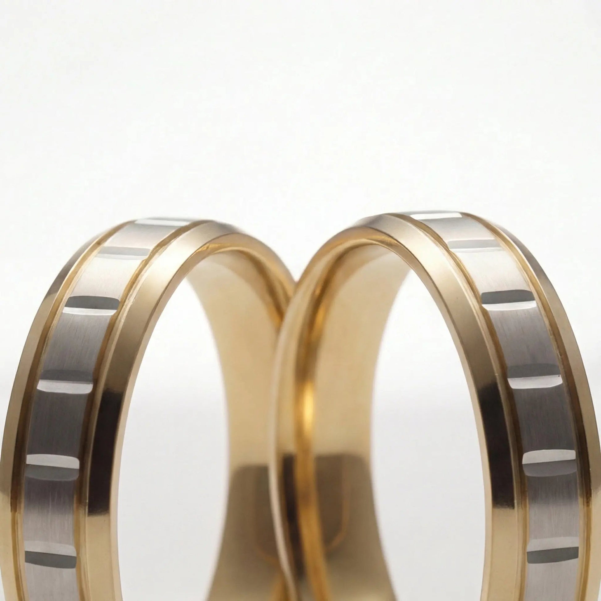 A 5mm gold wedding band with a star cut design in two-tone 9ct, 14ct, and 18ct gold by Majestic Jewellery