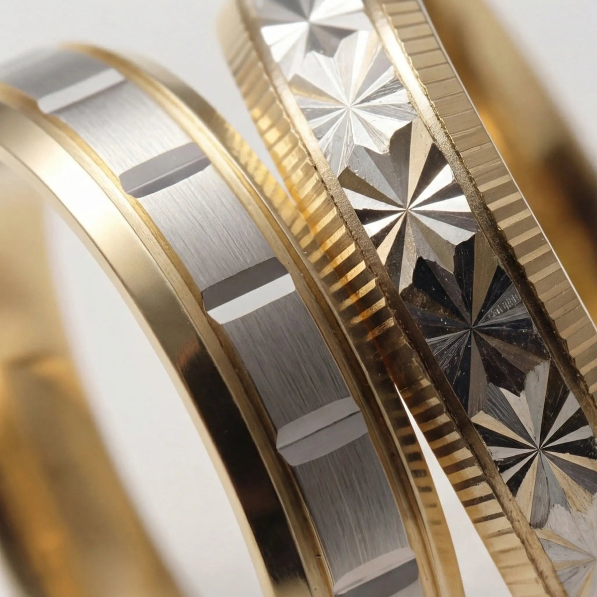 A 5mm gold wedding band with a star cut design in two tone 9ct, 14ct, and 18ct gold by Majestic Jewellery.