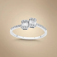 A 14ct white gold ring with two baguette diamonds and a 0.25ct center diamond, featuring an open design by Majestic Jewellery
