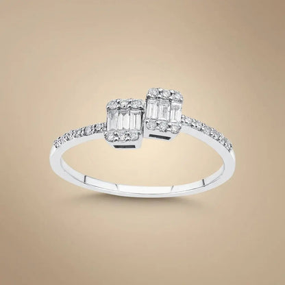 A 14ct white gold ring with two baguette diamonds and a 0.25ct center diamond, featuring an open design by Majestic Jewellery
