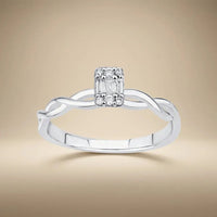 14ct white gold twisted baguette diamond ring with 0.12ct natural diamonds worn on a finger by Majestic Jewellery