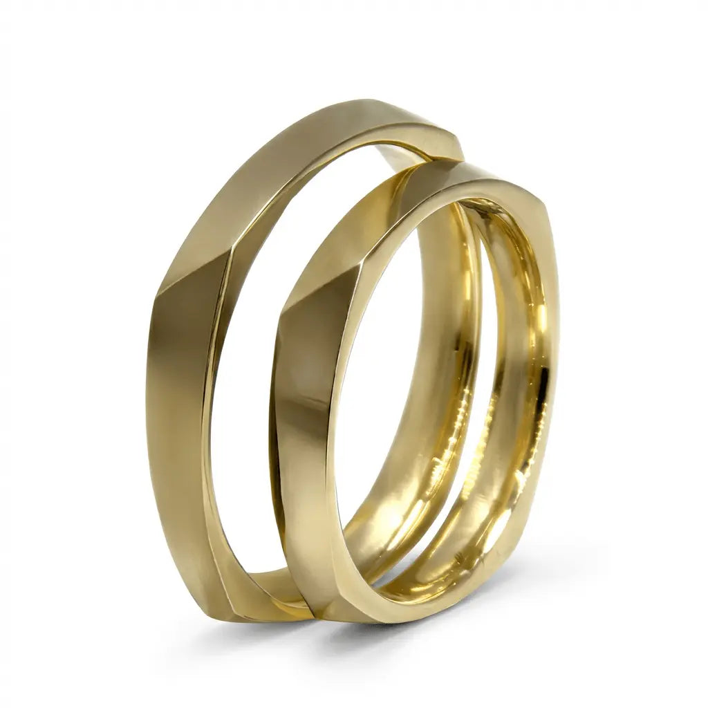 A 3mm faceted gold wedding band in 9ct gold, displayed on a white background with a subtle texture and reflective surface.